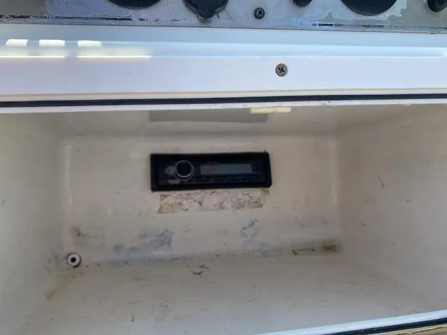 Slide: The Image of Storage compartment in a 2012 Pioneer 197 Venture boat with a built-in stereo system. - 13
