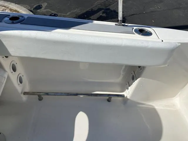 Slide: The Image of Interior view of a 2012 Pioneer 197 Venture boat, featuring seating and cup holders. - 16