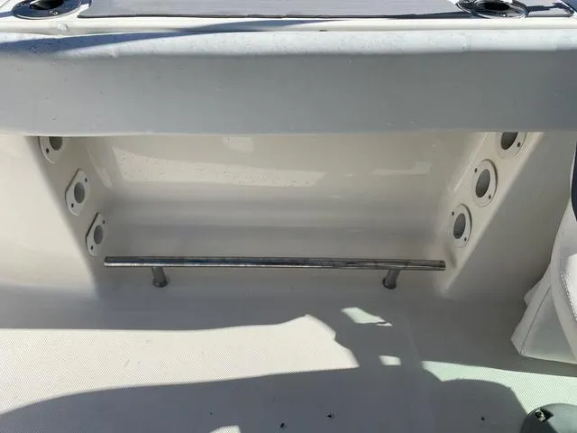 Slide: The Image of Interior view of a 2012 Pioneer 197 Venture boat, featuring rod holders and storage space. - 17