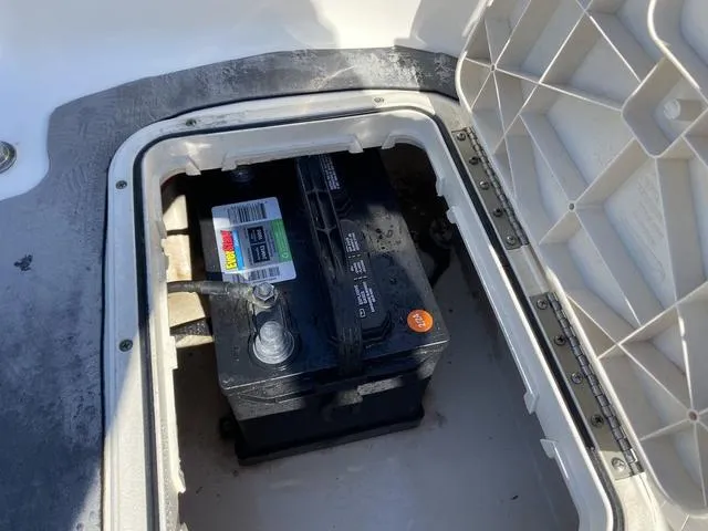 Slide: The Image of Battery compartment of a 2012 Pioneer 197 Venture boat, showing a secured marine battery. - 19