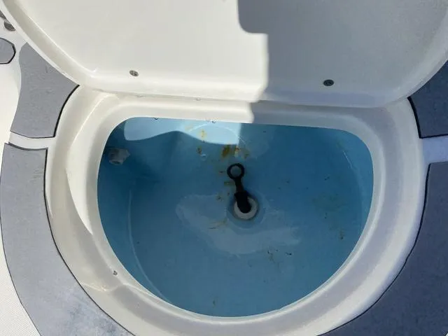 Slide: The Image of Open livewell in 2012 Pioneer 197 Venture boat, showing interior and drain plug. - 21