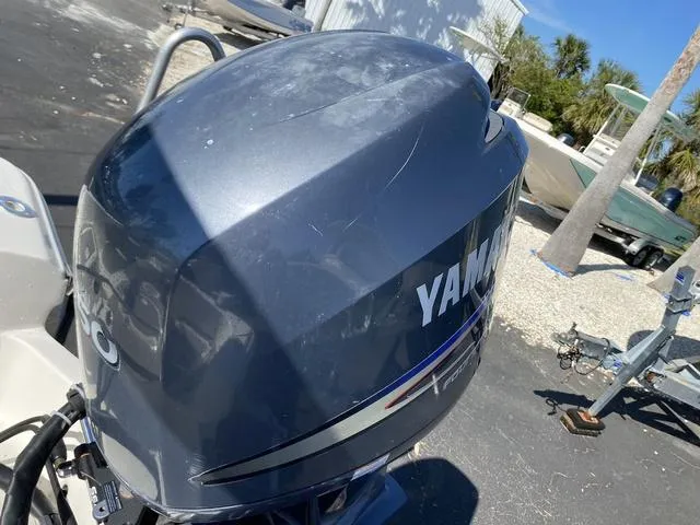 Slide: The Image of Outboard motor on a 2012 Pioneer 197 Venture boat, parked outdoors. - 22