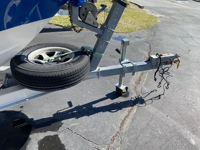 Slide: The Image of Trailer hitch of a 2012 Pioneer 197 Venture boat on pavement. - 28