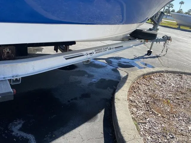 Slide: The Image of Trailer with a 2012 Pioneer 197 Venture boat parked on pavement. - 29