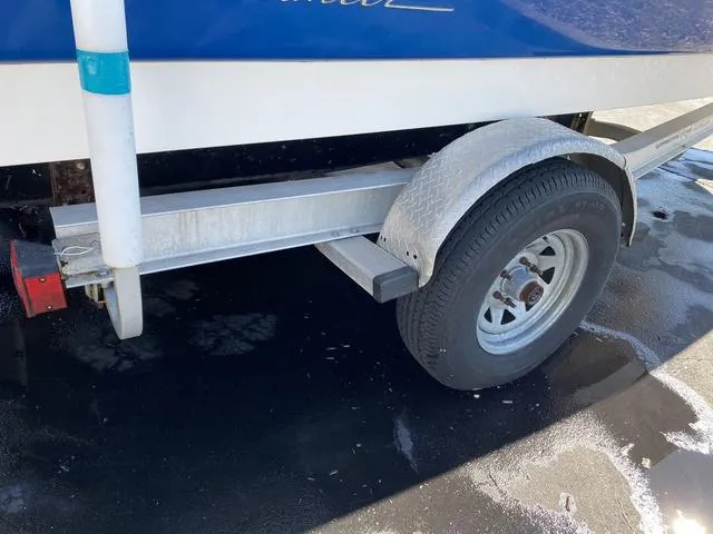 Slide: The Image of Trailer wheel of a 2012 Pioneer 197 Venture boat on wet pavement. - 30