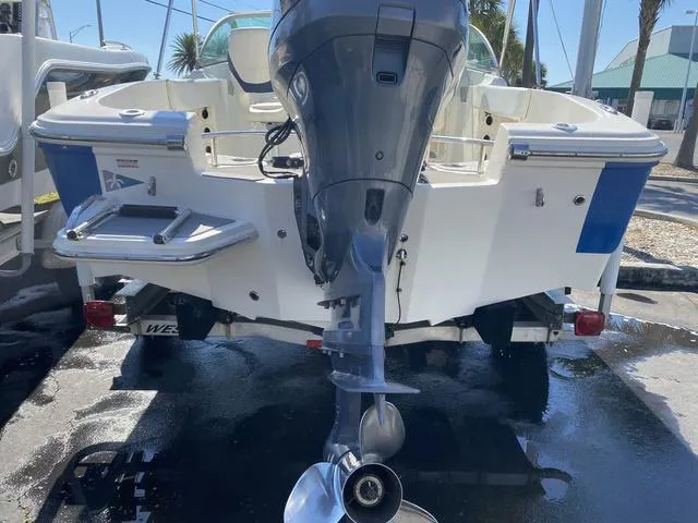 Slide: The Image of 2012 Pioneer 197 Venture boat with outboard motor, rear view in marina setting. - 6