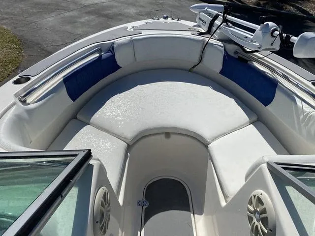 Slide: The Image of 2012 Pioneer 197 Venture boat interior with white seating and blue accents. - 7