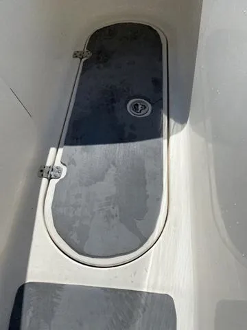 Slide: The Image of 2012 Pioneer 197 Venture boat storage compartment with hinged lid. - 9