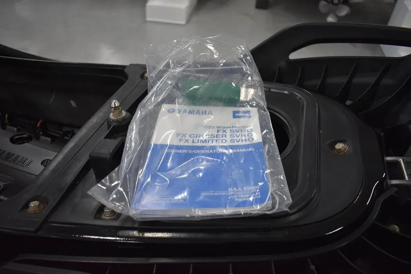 Slide: The Image of 2023 Yamaha WaveRunner FX SVHO with Audio System manual in storage compartment. - 34