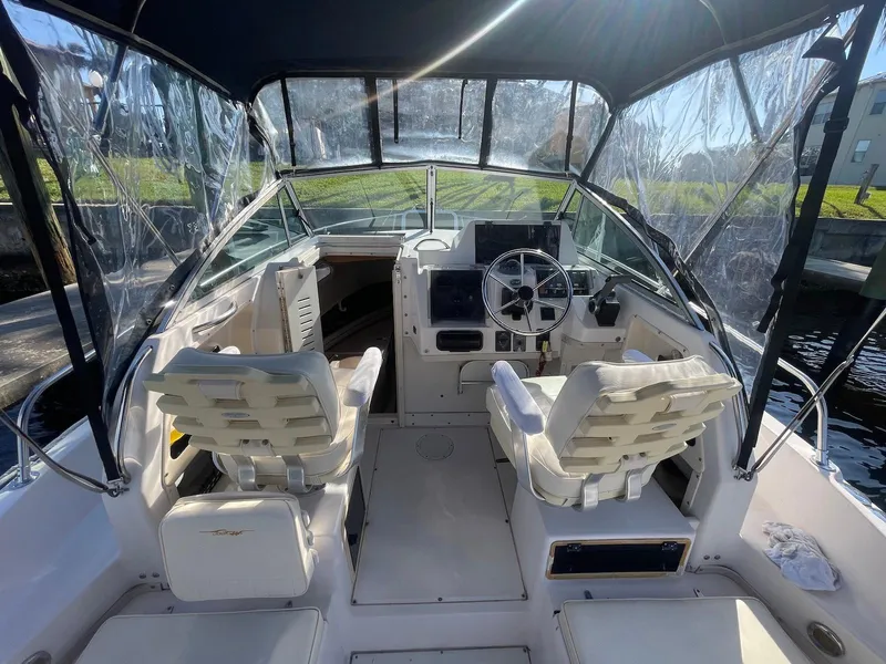 Slide: The Image of 2001 Grady-White Gulfstream 232 boat interior with helm, seating, and clear canopy. - 15