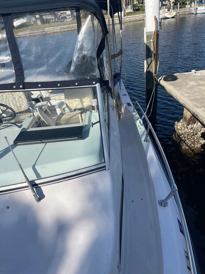 Slide: The Image of 2001 Grady-White Gulfstream 232 boat docked by the water. - 19