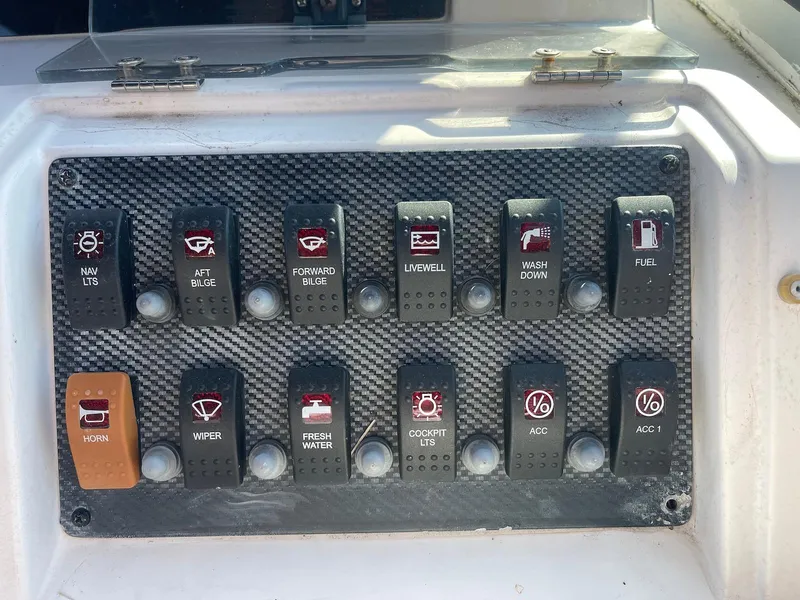 Slide: The Image of Control panel of a 2001 Grady-White Gulfstream 232 boat with labeled switches. - 20