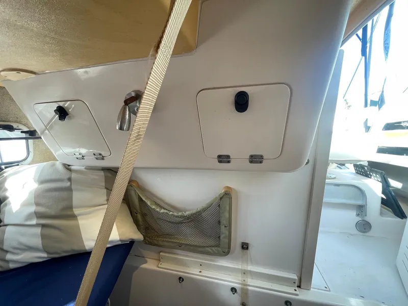 Slide: The Image of 2001 Grady-White Gulfstream 232 cabin interior with storage compartments and seating. - 21