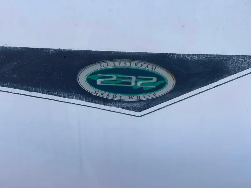Slide: The Image of 2001 Grady-White Gulfstream 232 boat emblem on a textured surface. - 22