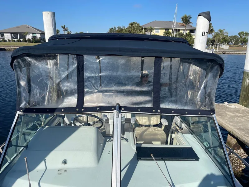 Slide: The Image of 2001 Grady-White Gulfstream 232 boat with clear canopy docked at marina. - 23