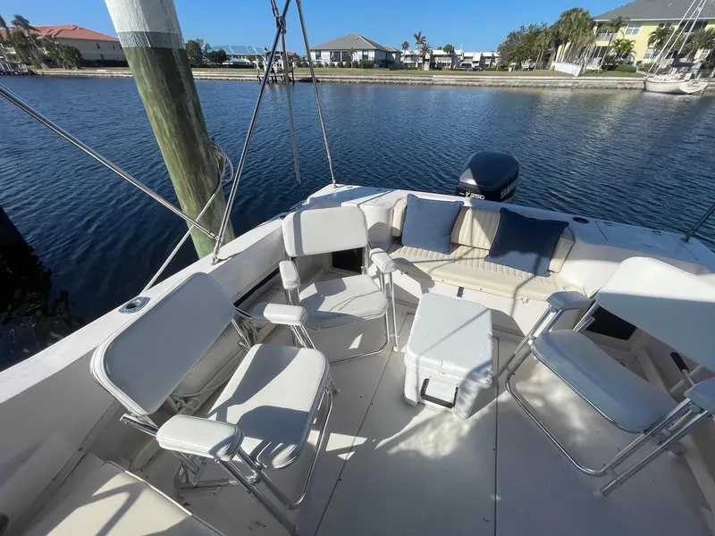 Slide: The Image of 2001 Grady-White Gulfstream 232 boat with seating area, docked by waterfront homes. - 5