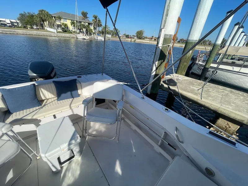 Slide: The Image of 2001 Grady-White Gulfstream 232 boat docked by a serene waterfront. - 6