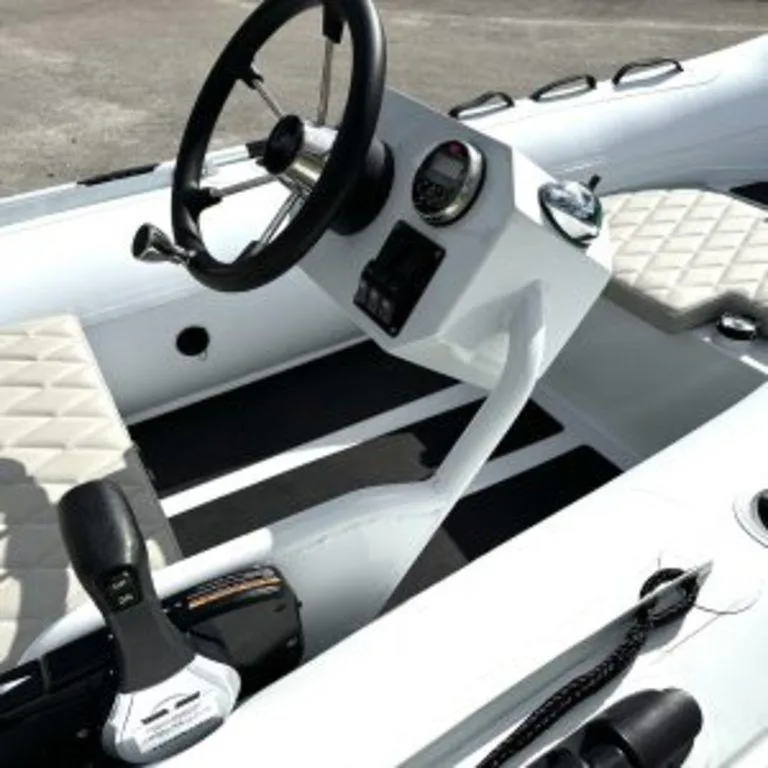 Slide: The Image of 2024 EastMarine Godiac 320 Ultra-light boat interior with steering wheel and control panel. - 11