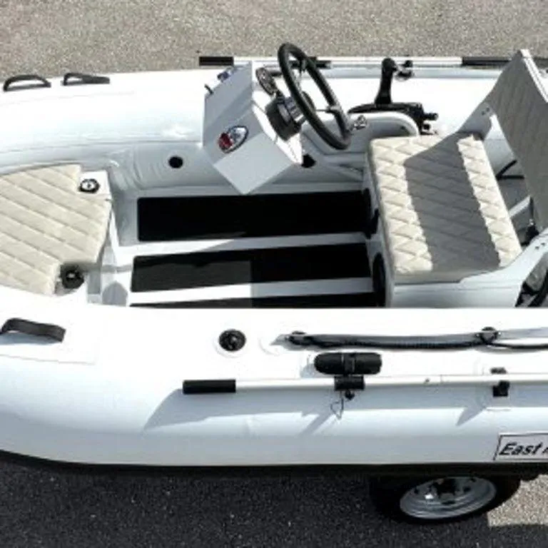 Slide: The Image of 2024 EastMarine Godiac 320 Ultra-light inflatable boat with steering wheel and cushioned seats. - 12
