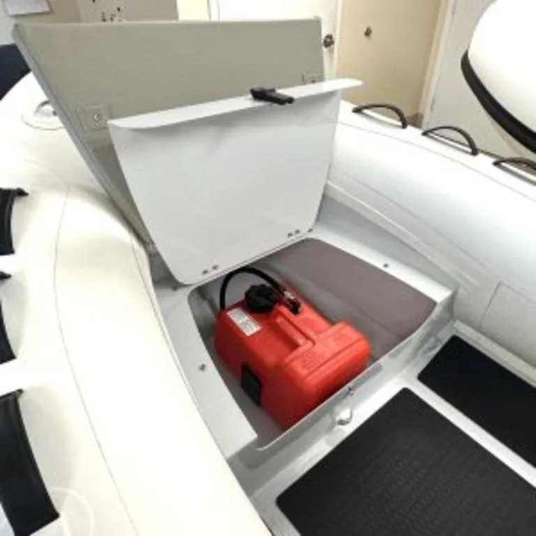 Slide: The Image of 2024 EastMarine Godiac 320 Ultra-light boat storage compartment with red fuel tank. - 2