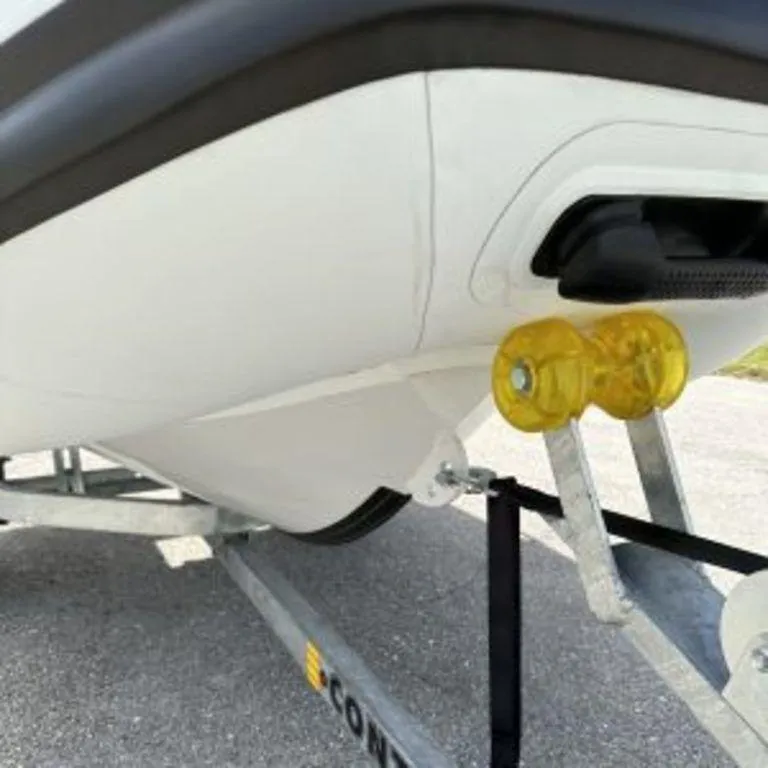 Slide: The Image of 2024 EastMarine Godiac 320 Ultra-light boat on trailer, close-up view. - 5