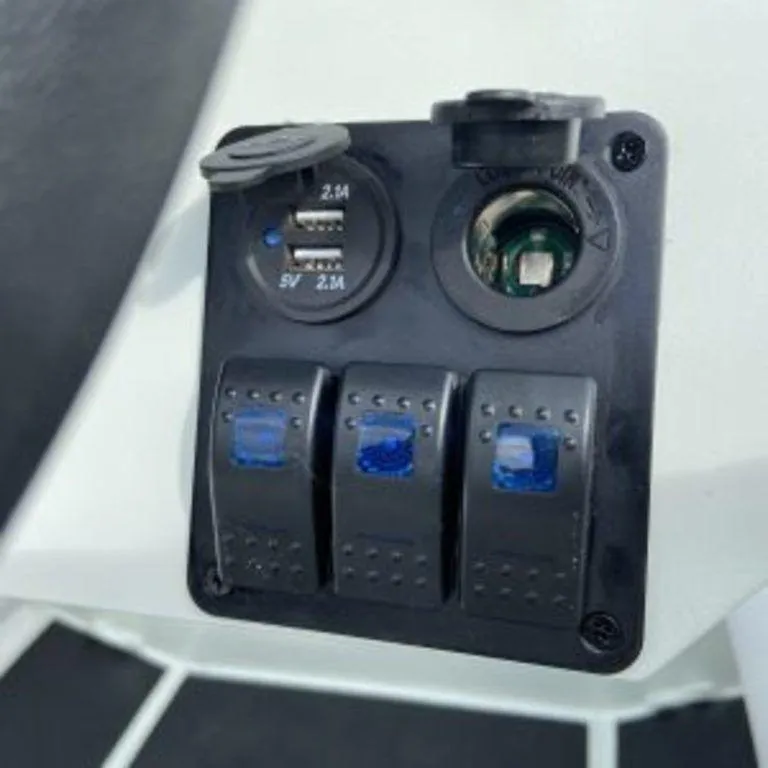 Slide: The Image of Control panel with USB ports and switches on 2024 EastMarine Godiac 320 Ultra-light boat. - 6