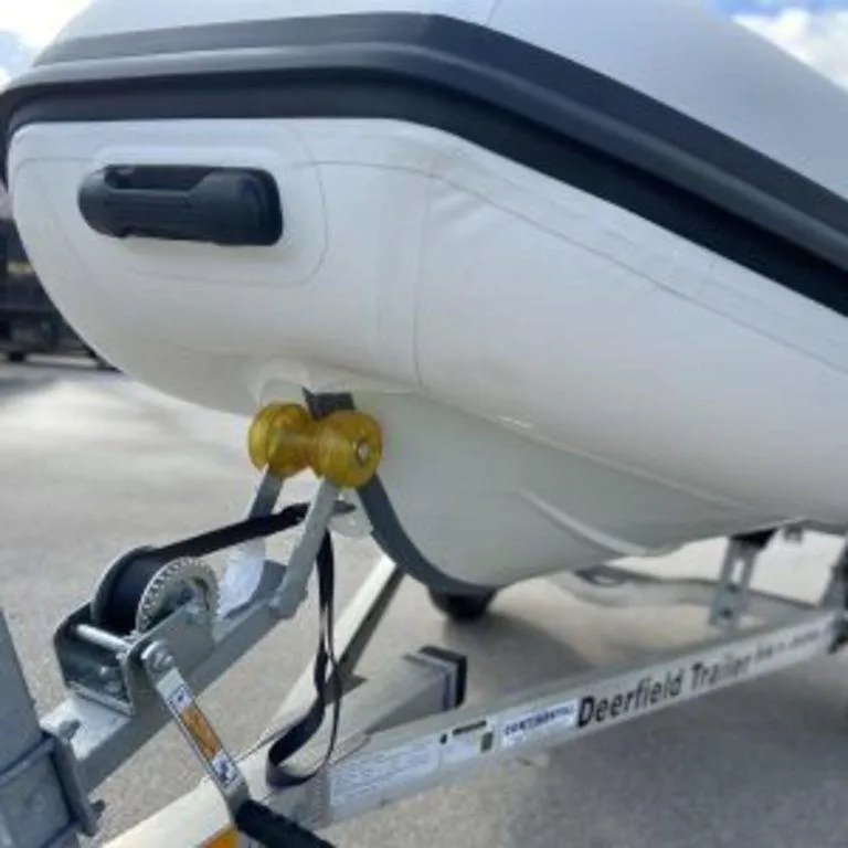 Slide: The Image of 2024 EastMarine Godiac 320 Ultra-light boat on trailer, close-up view. - 7