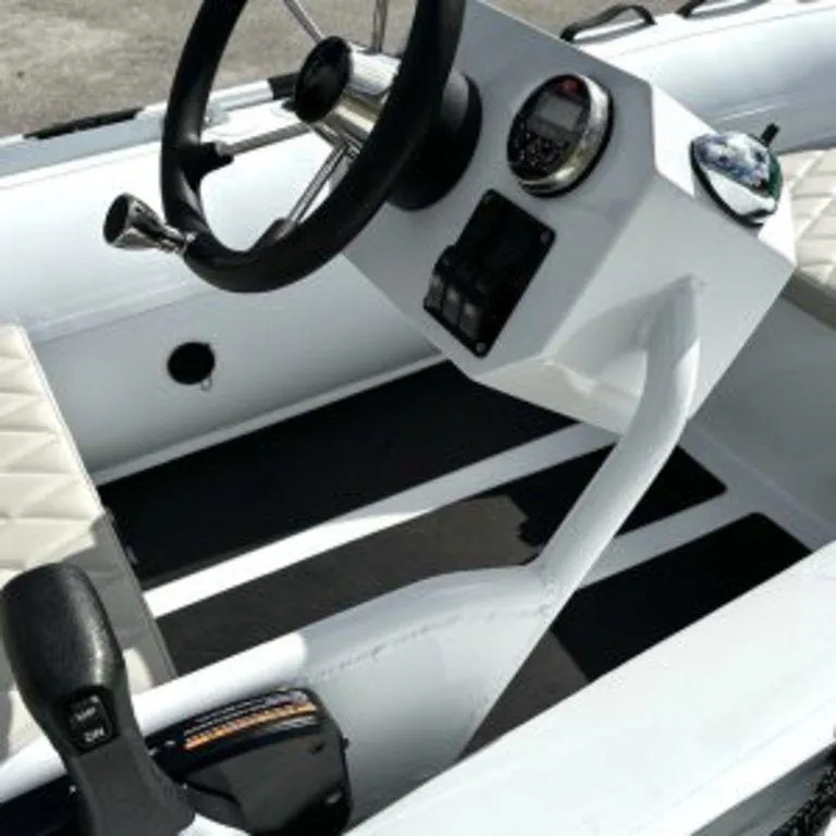 Slide: The Image of 2024 EastMarine Godiac 320 Ultra-light boat interior with steering wheel and control panel. - 8