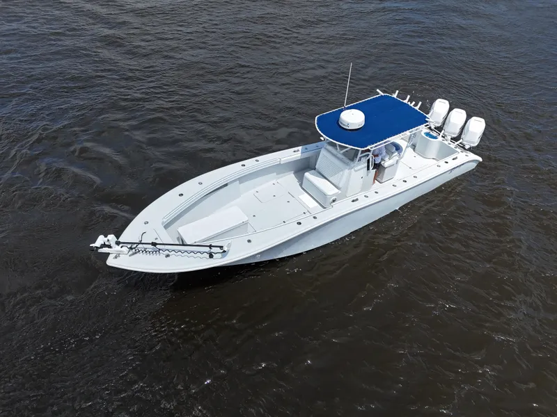 Slide: The Image of 2003 Yellowfin 36 Offshore boat with blue canopy on open water. - 11