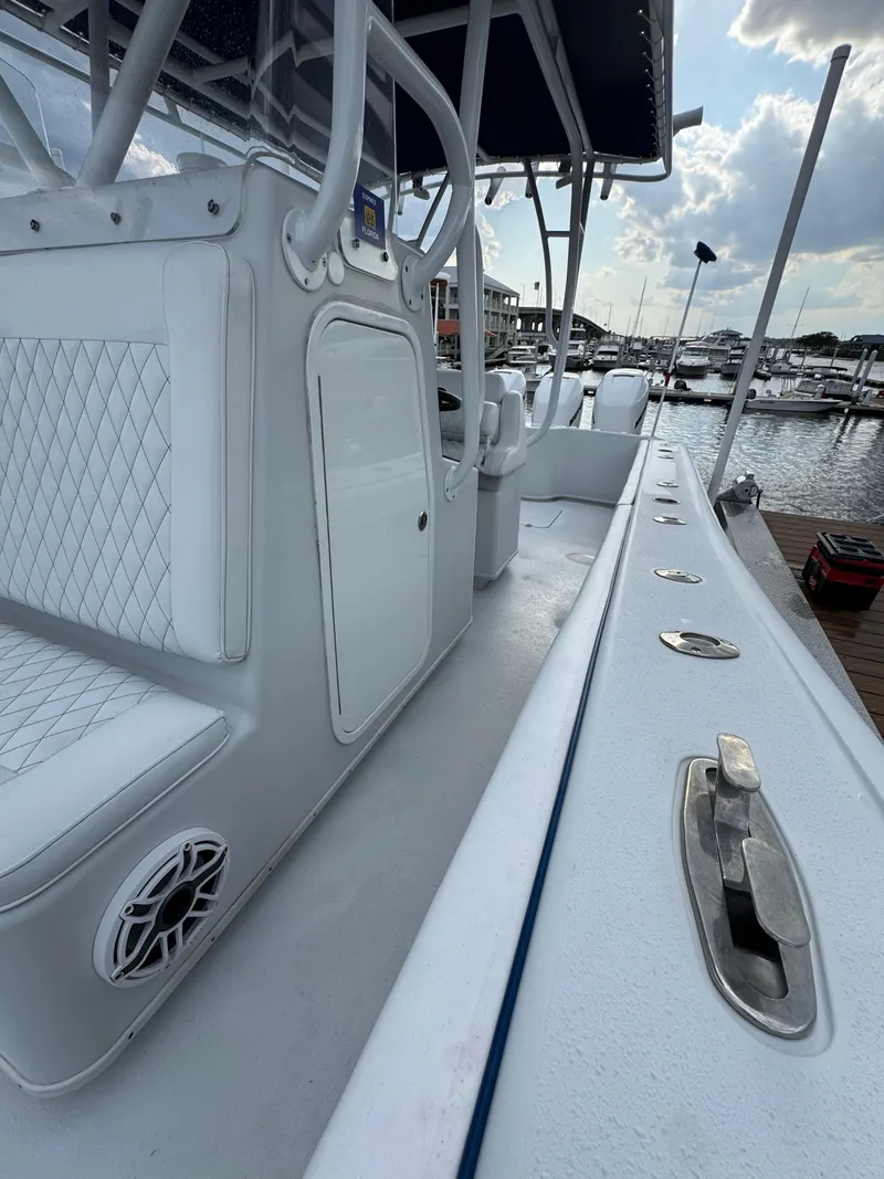 Slide: The Image of 2003 Yellowfin 36 Offshore boat docked, featuring sleek design and spacious seating. - 19