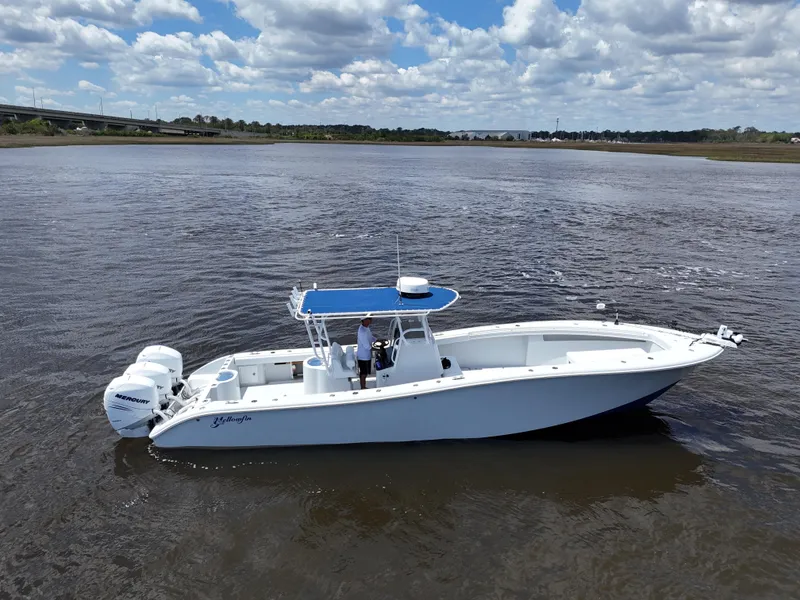 Slide: The Image of 2003 Yellowfin 36 Offshore boat on calm water under a partly cloudy sky. - 2