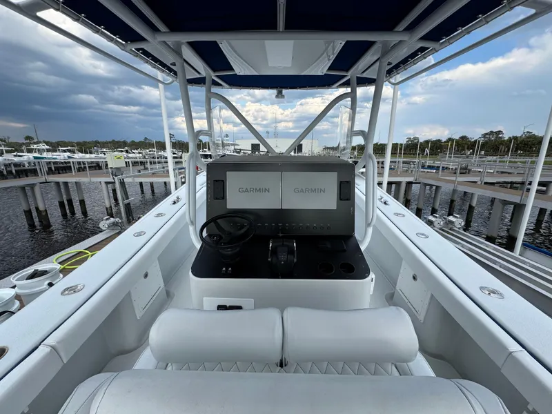 Slide: The Image of 2003 Yellowfin 36 Offshore boat with Garmin navigation, docked at marina under cloudy sky. - 20