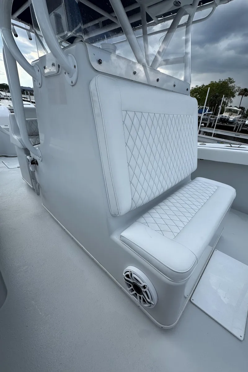 Slide: The Image of 2003 Yellowfin 36 Offshore boat with white cushioned seating and speaker detail. - 25