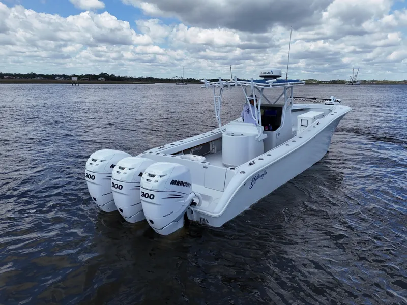 Slide: The Image of 2003 Yellowfin 36 Offshore boat with triple Mercury 300 engines on open water. - 3