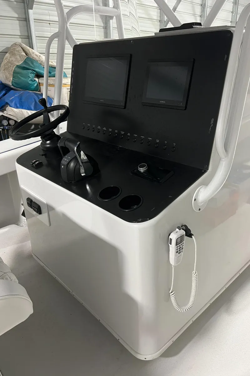 Slide: The Image of 2003 Yellowfin 36 Offshore boat console with dual screens and steering wheel. - 31