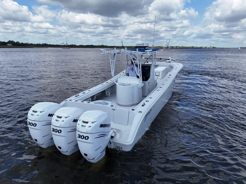 Slide: The Image of 2003 Yellowfin 36 Offshore boat with triple Mercury 300 engines on open water. - 5