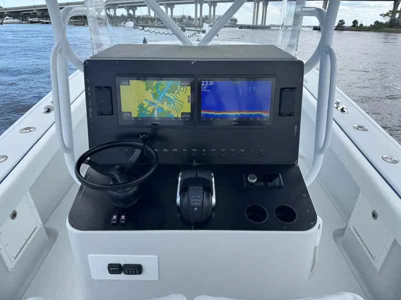 Slide: The Image of 2003 Yellowfin 36 Offshore boat console with navigation screens and steering wheel. - 7