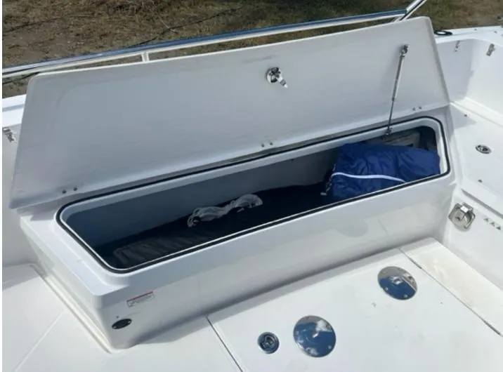 Slide: The Image of Open storage compartment on a 2020 Axopar 28 boat, showing interior space. - 11