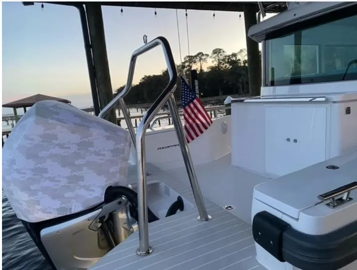 Slide: The Image of 2020 Axopar 28 boat with American flag, docked at sunset. - 3