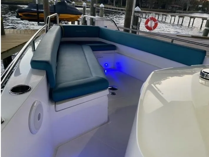 Slide: The Image of 2020 Axopar 28 boat interior with blue seating and ambient lighting. - 8