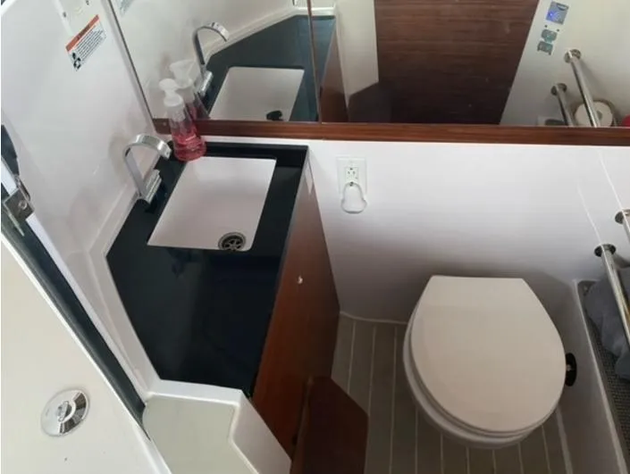 Slide: The Image of Bathroom interior of 2020 Axopar 28 boat with sink and toilet. - 9