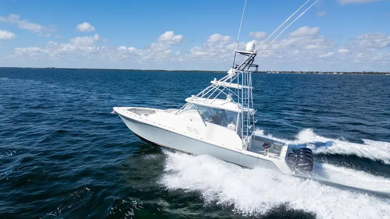 Slide: The Image of 2015 SeaVee 430 Fisharound cruising on open water under a clear blue sky. - 13