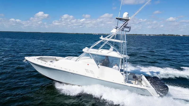 Slide: The Image of 2015 SeaVee 430 Fisharound boat cruising on open water under a clear sky. - 14