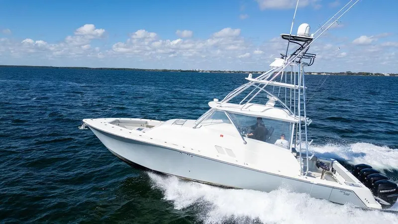 Slide: The Image of 2015 SeaVee 430 Fisharound boat cruising on open water under a clear sky. - 15