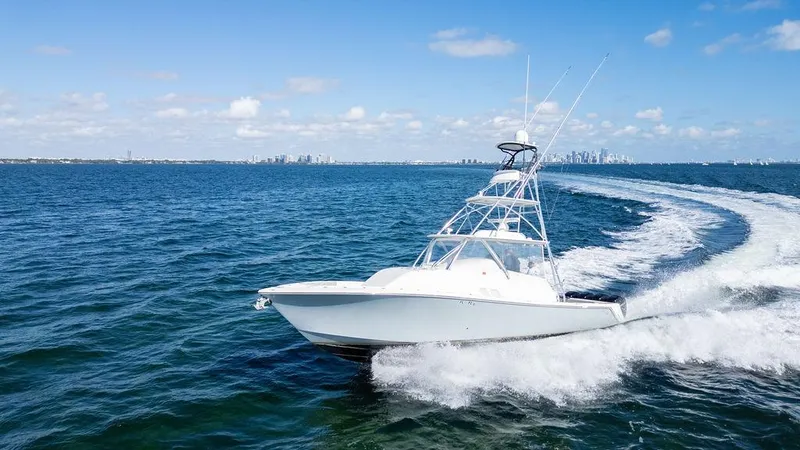 Slide: The Image of 2015 SeaVee 430 Fisharound cruising on open water under clear blue skies. - 16