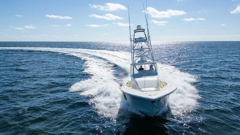Slide: The Image of 2015 SeaVee 430 Fisharound cruising on open ocean under clear blue sky. - 19