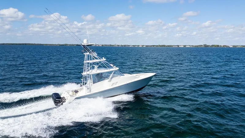 Slide: The Image of 2015 SeaVee 430 Fisharound cruising on open water under a clear blue sky. - 22
