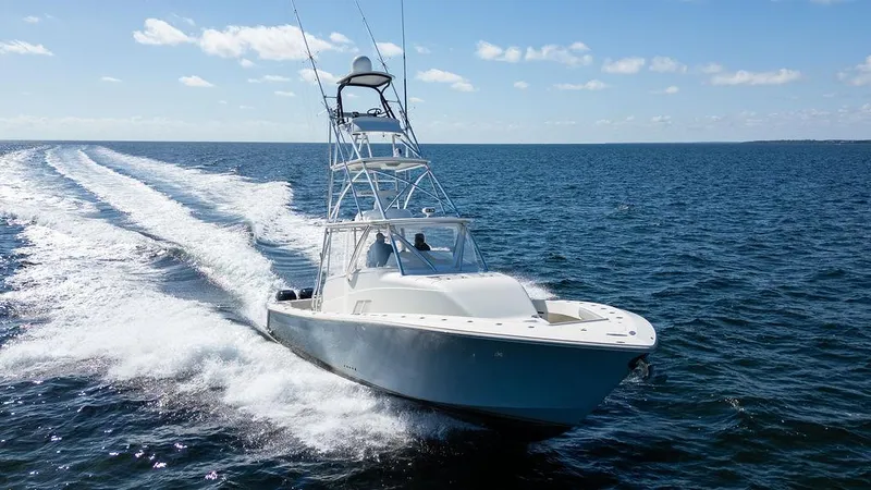 Slide: The Image of 2015 SeaVee 430 Fisharound cruising on open water under clear skies. - 26