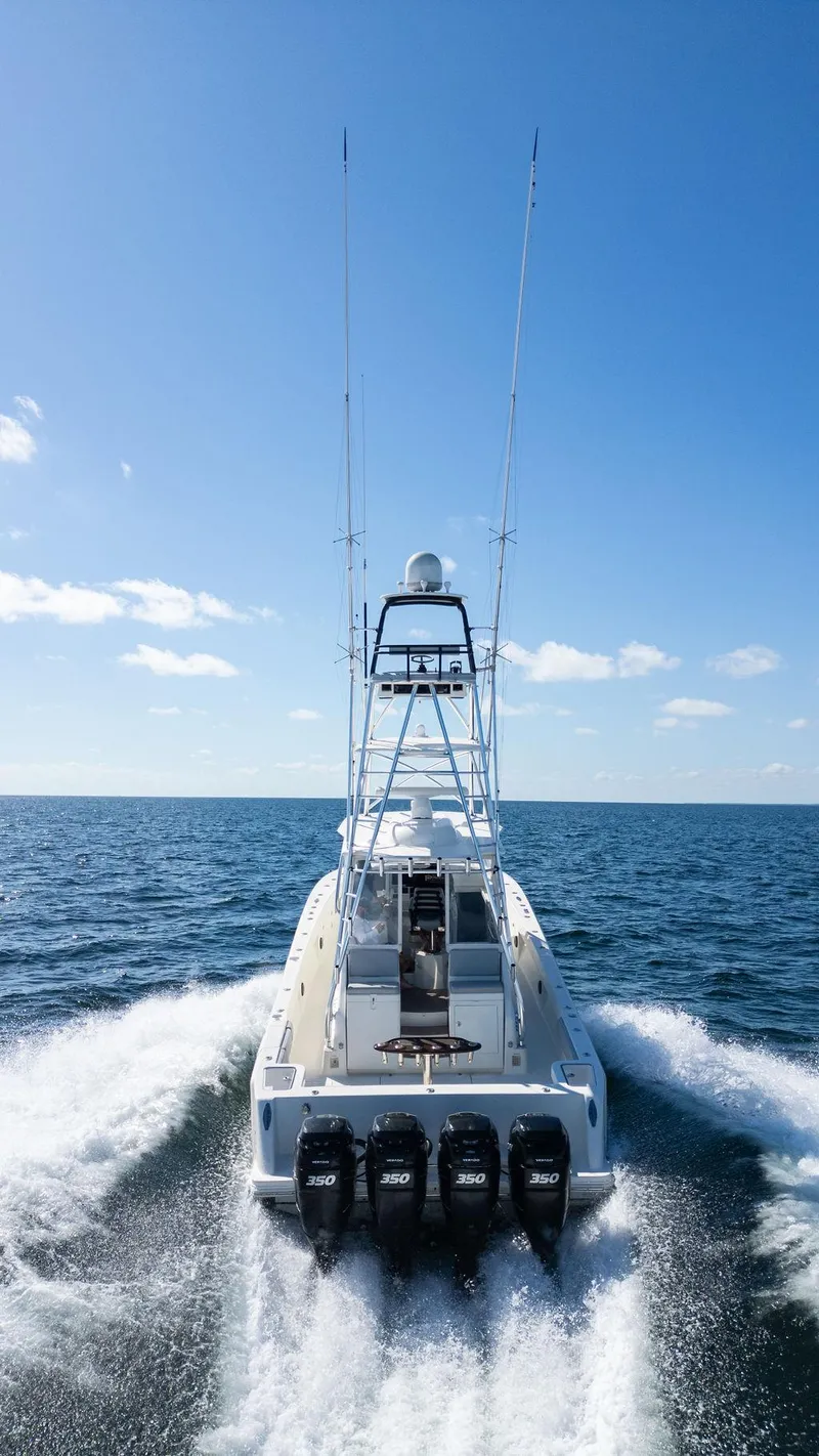Slide: The Image of 2015 SeaVee 430 Fisharound cruising on open water under clear blue sky. - 28