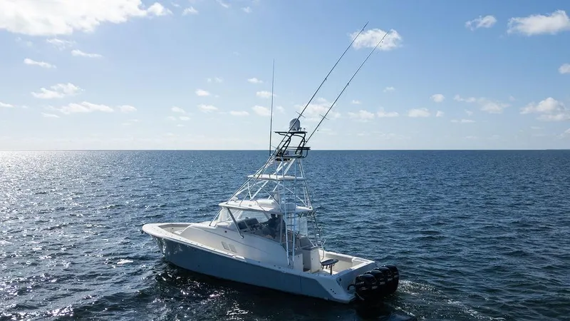 Slide: The Image of 2015 SeaVee 430 Fisharound boat cruising on open ocean under clear sky. - 3